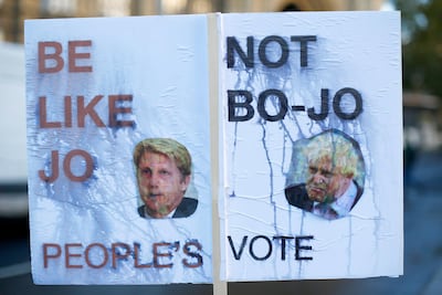 A rain damaged placard in favour of a second Brexit referendum features pictures of former Foreign Secretary Boris Johnson, and former Transport Minister Jo Johnson, in Westminster, London, Britain, November 12, 2018. REUTERS/Henry Nicholls