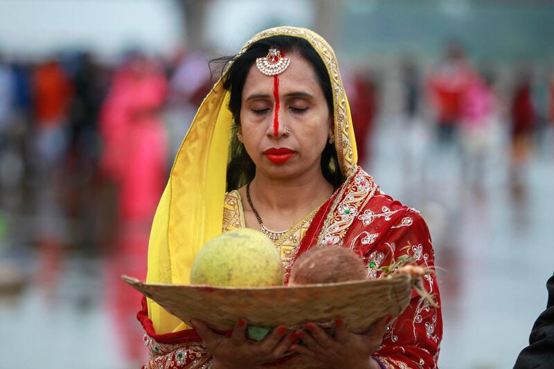 A Hindu woman devotee offers prayers to the Sun God in the Tawi River in Jammu, India. AP Photo