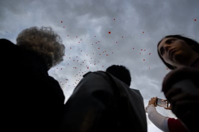 Relatives of the Bibas family and their supporters watch as symbolic orange balloons are released during a rally last week in Tel Aviv. Getty