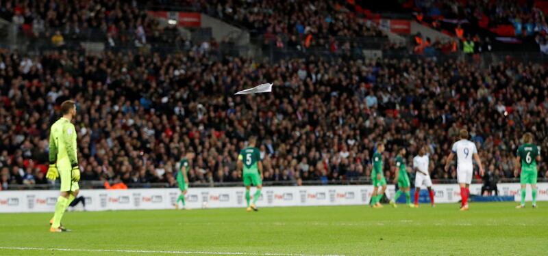 Paper aeroplanes are thrown onto the pitch by fans. Carl Recine / Reuters