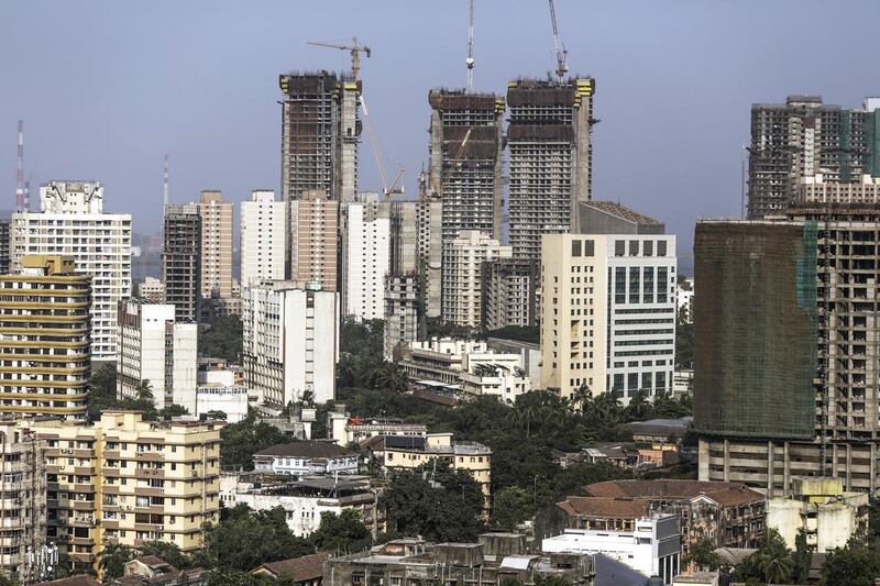 Towers stand under construction among other residential and commercial buildings in the Mahalaxmi area of Mumbai. Dhiraj Singh / Bloomberg