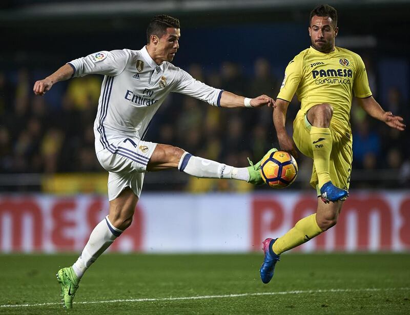 Villarreal’s Mario Gaspar, right, competes for the ball with Cristiano Ronaldo of Real Madrid. Getty Images