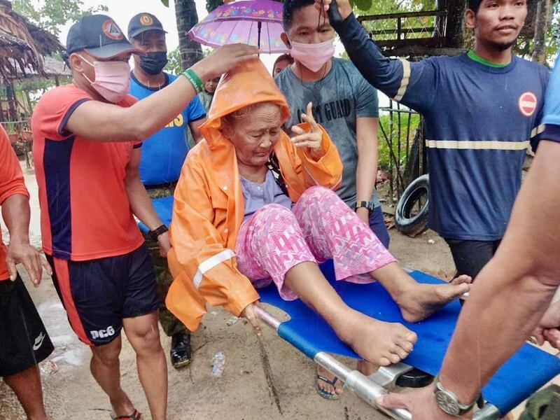 A woman is rescued from her home. Photo: EPA