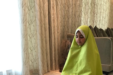 Maryam Al Nuaimi, 8, recites her prayers at home during Ramadan. Courtesy - Nawal Al Hammadi 