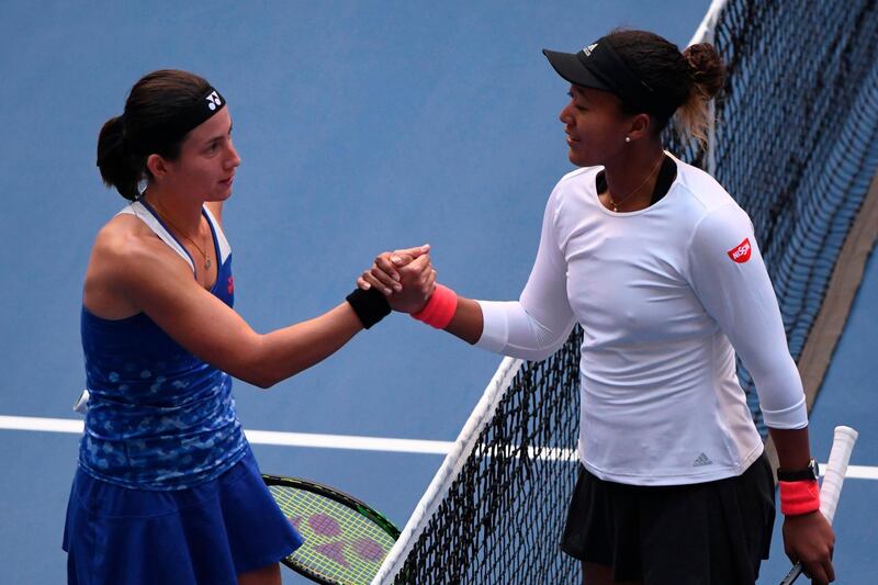 Anastasija Sevastova of Latvia (L) shakes hands with Naomi Osaka of Japan at the end of their women's singles semi finale match at the China Open tennis tournament in Beijing on October 6, 2018. / AFP / FRED DUFOUR
