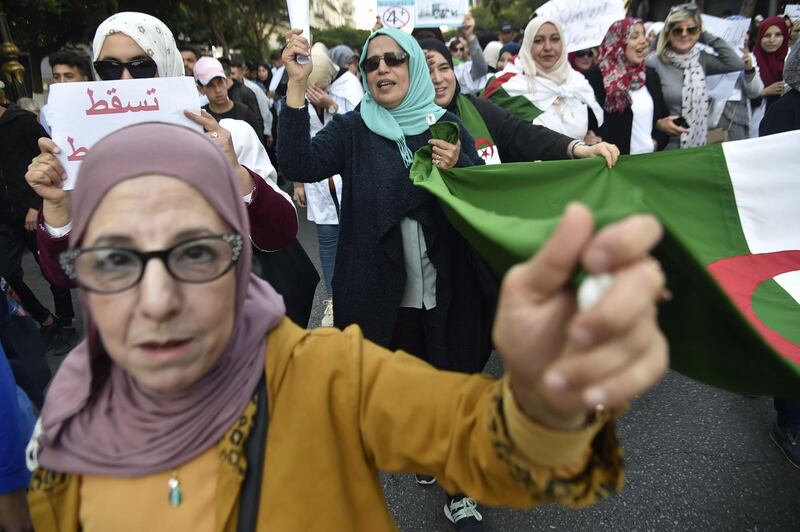 Algerian school teachers shout slogans during a protest in central Algiers on March 13, 2019 against President Abdelaziz Bouteflika's bid to prolong his two-decade rule.  A thousand teachers started the protest in the morning before being joined by students, a teacher at the site told AFP. / AFP / RYAD KRAMDI                        
