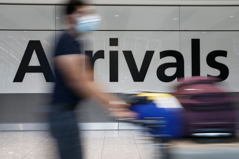 A traveller exits through the International Arrivals gate at Heathrow Airport in London, England. Getty Images