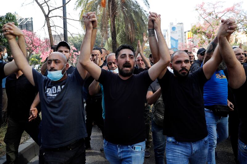 Demonstrators chant slogans against Judge Tarek Bitar, who is investigating last year's deadly Beirut port blast.  AP