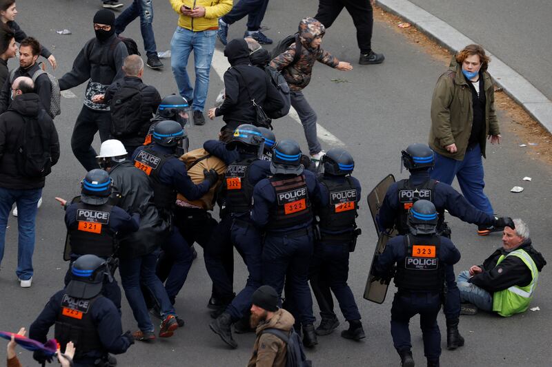 French riot police apprehend protesters on the Place de la Bastille. Reuters