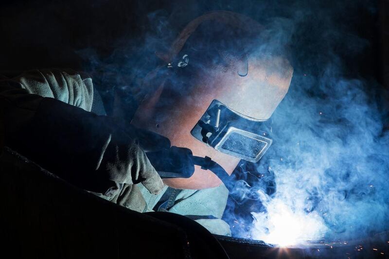 An employee welds components of a ship at the Hyundai Heavy Industries shipyard.