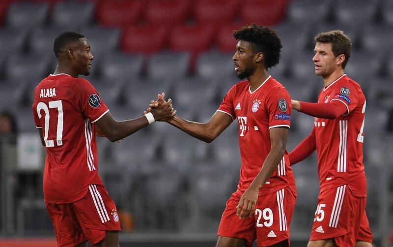 Bayern Munich's Austrian defender David Alaba, left, congratulates French forward Kingsley Coman on scoring the opening goal during the UEFA Champions League Group A match against Atletico Madrid in Munich. AFP