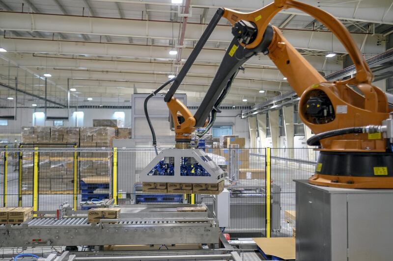 A robotic arm lifts boxes of Chuckie, a Nestle SA chocolate flavored milk drink, at the company's factory in Batangas province, the Philippines, on Tuesday, April 2, 2019. Nestle Philippines targets to double production of its chocolate milk brand product with its new 2.8b-peso plant in Batangas province, chairman and CEO Kais Marzouki says. Photographer: Veejay Villafranca/Bloomberg