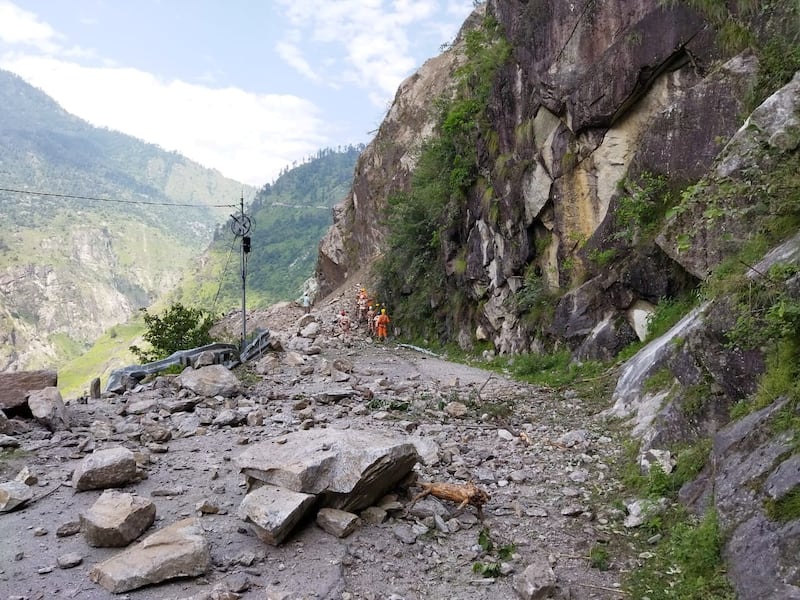 A bus carrying 50 passengers and two other vehicles were struck by the landslide.