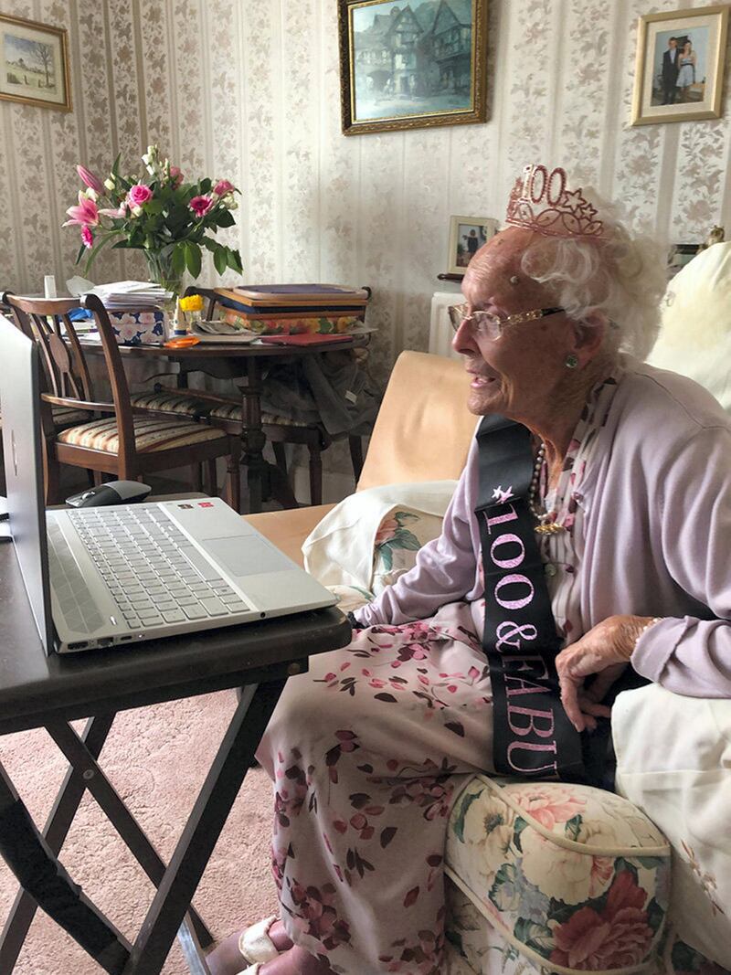 My mum's excitement on her 100th birthday having received a card from Her Majesty The Queen, with whom she shares her birthday, and celebrating by chatting on the computer video with all the family during the Coronavirus lockdown by ANITA REILLY
