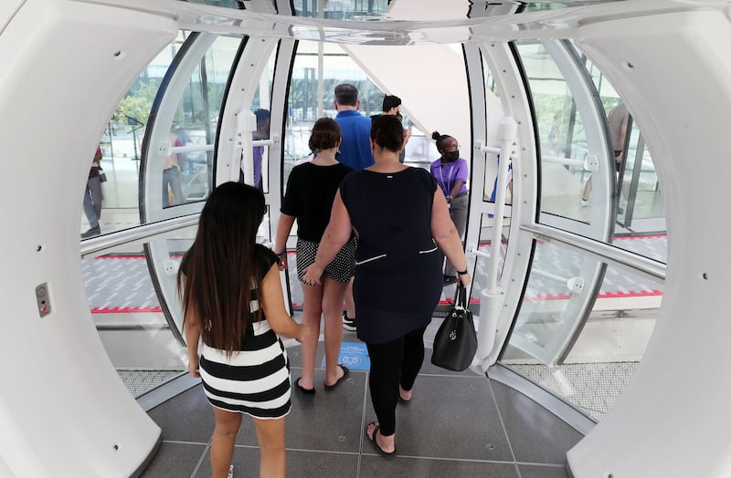 Guests step aboard a cabin for the first ride on Ain Dubai