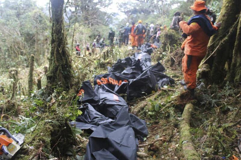 A rescue team member stands near bodies recovered from the crashed Trigana Air plane near Oksibil, Bintang Mountains district, Papua province, Indonesia, Basarnas / Handout via Reuters 