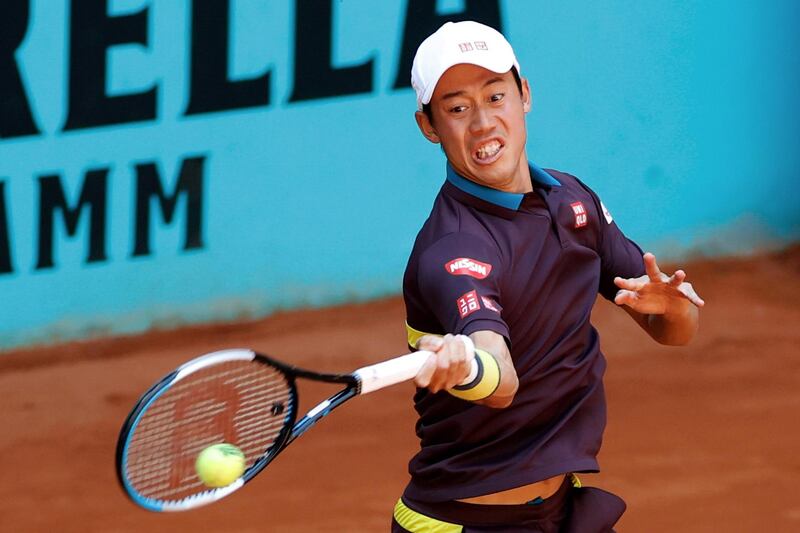 epa09179080 Kei Nishikori of Japan in action against Alexander Zverev of Germany during their Mutua Madrid Open round of 32 match in Madrid, Spain, 05 May 2021.  EPA/CHEMA MOYA