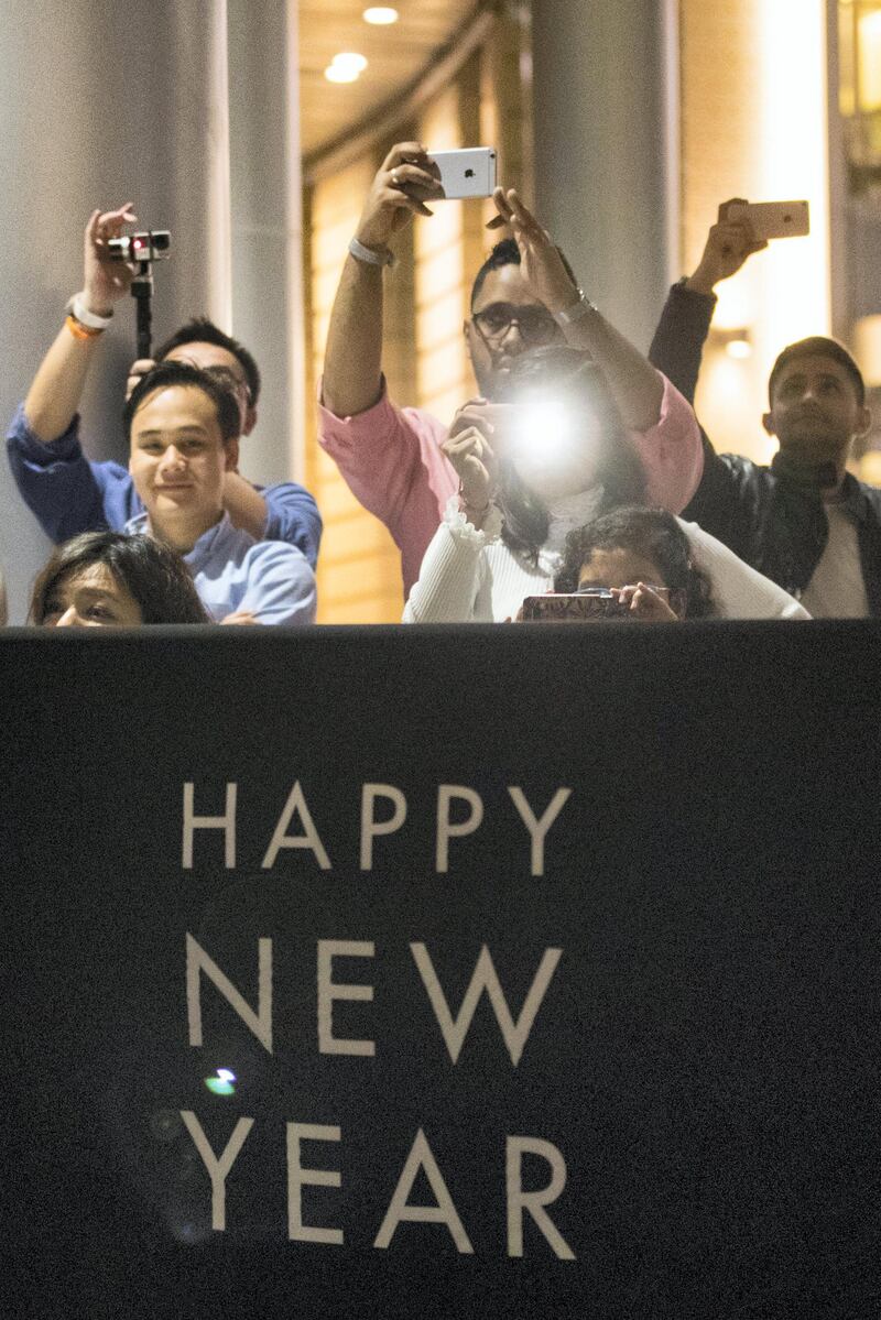 Dubai, United Arab Emirates, December 31, 2017:    Revellers watch the Dubai Mall fountain ahead of New Years Eve celebrations on in the downtown area of Dubai on December 31, 2017. Christopher Pike / The National

Reporter:  N/A
Section: News