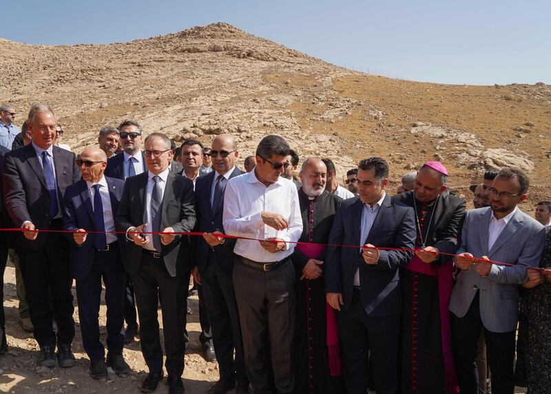 Italian archaeologist Daniele Morandi Bonacossi, left, Italian ambassador in Iraq Maurizio Greganti, third left, Governor of Dohuk Ali Tatar, centre, Bishop of the Chaldean Diocese of Alqosh Mar Boulos Thabet, second right, and Director of Antiquities of Dohuk Governorate Bekas Brefkany, right, take part in a ribbon-cutting ceremony for the opening of the first phase.