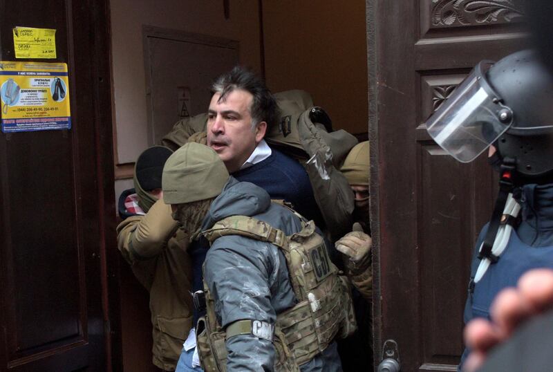 The Ukrainian Security Service officers detain Mikheil Saakashvili at the entrance of his house in Kiev, Ukraine, Tuesday, Dec. 5, 2017.  Ukraine's prosecutor-general announced late Friday, Dec. 8, 2017, that opposition figure Mikheil Saakashvili has been arrested. (AP Photo/Evgeniy Maloletka)