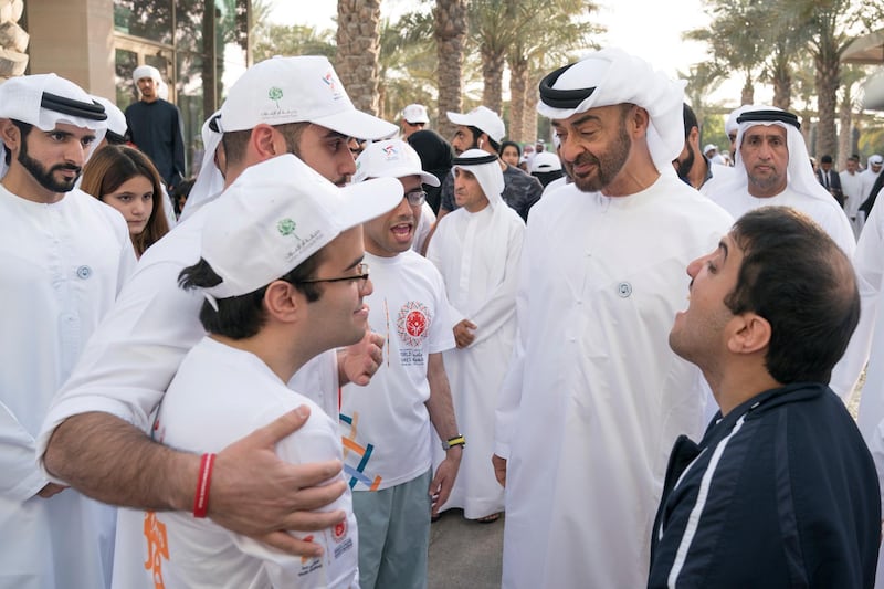ABU DHABI, UNITED ARAB EMIRATES - January 26, 2018: HH Sheikh Mohamed bin Zayed Al Nahyan, Crown Prince of Abu Dhabi and Deputy Supreme Commander of the UAE Armed Forces (2nd R), speaks with a participant during the   Special Olympics Wold Games Abu Dhabi 2019 initiative "Walk Unified", at Umm Al Emarat Park. Seen with HH Sheikh Hamdan bin Mohamed Al Maktoum, Crown Prince of Dubai (L), 

( Hamad Al Kaabi / Crown Prince Court - Abu Dhabi )
—