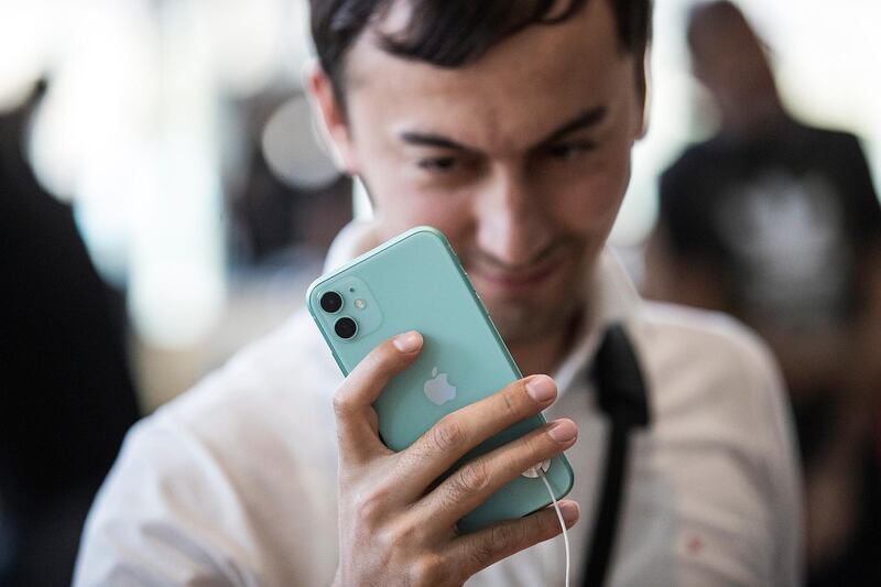 A customer looks at the new iPhone 11 in Dubai. EPA