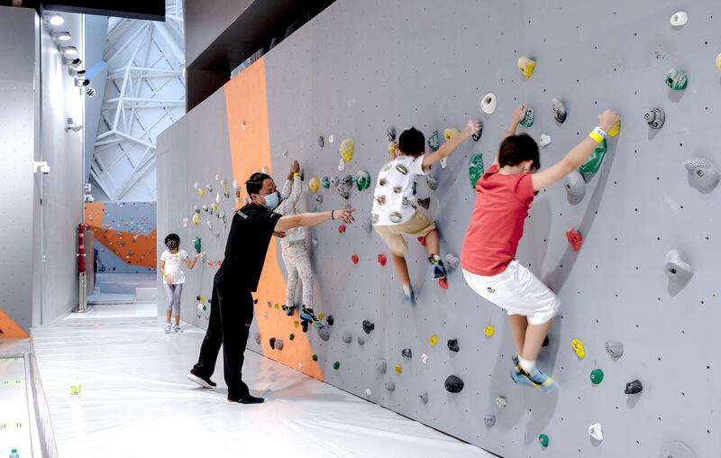 Abu Dhabi, United Arab Emirates, August 20, 2020.   Budding wall climbers scale the walls of Cymb Abu Dhabi with an instructor guiding the way.
Victor Besa /The National
Section:  NA
Reporter:  Jason Von Berg