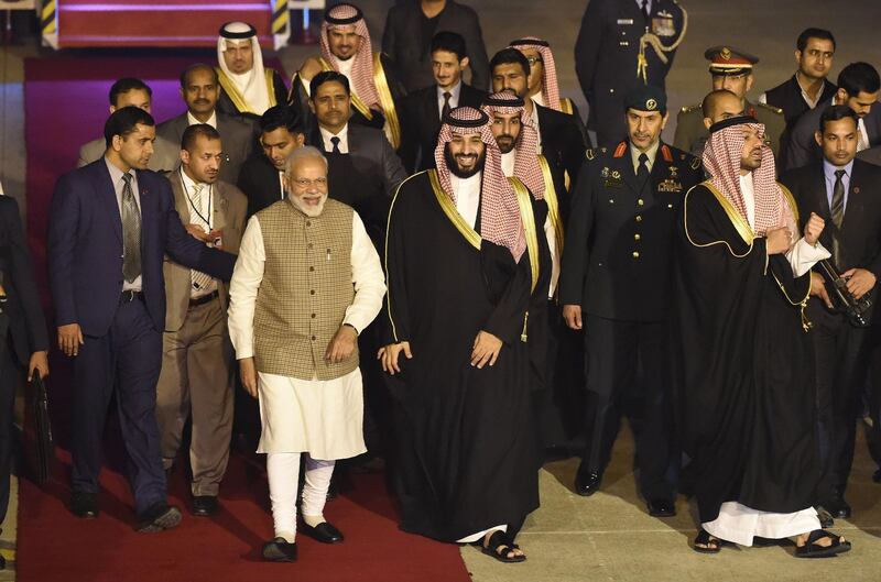 Saudi Crown Prince Mohammed Bin Salman (centre right) walks next to Indian Prime Minister Narendra Modi upon arriving at the airport in New Delhi. AFP