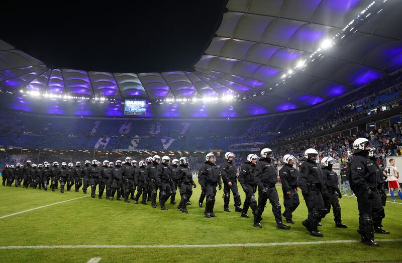Police leave the pitch after a Bundesliga match between Hamburg and VfB Stuttgart. Getty