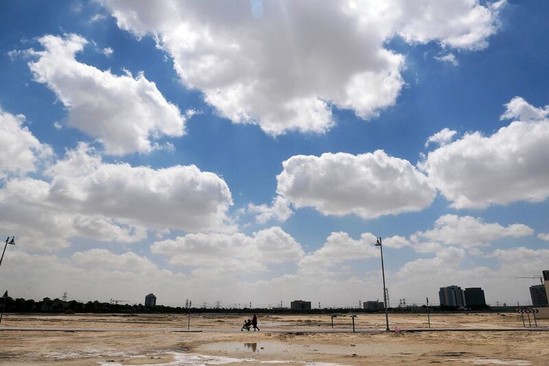 DUBAI, UNITED ARAB EMIRATES , March 24 – 2020 :- One of the lady walking with her kids during the cloudy sky in Al Furjan area in Dubai. People are staying home as a preventive measure against coronavirus in Dubai. (Pawan Singh / The National) For News/Online/Instagram/Big Picture/Standalone