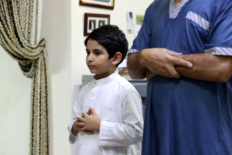 Rayan prays with his dad Yousef and explains what it means to observe his first Ramadan fast. Chris Whiteoak / The National