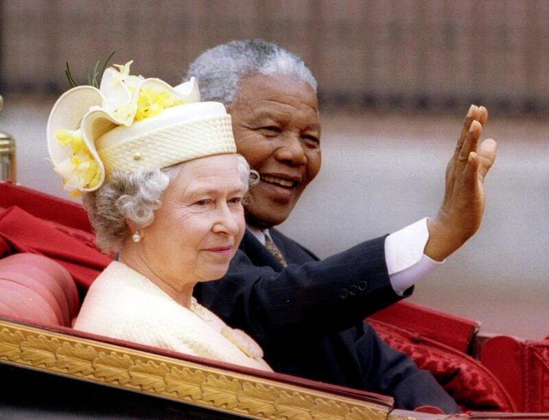 South Africa’s President Nelson Mandela and Britain’s Queen Elizabeth II ride in a carriage outside Buckingham Palace on the first day of a state visit to Britain, on July 9, 1996 file photo. Reuters