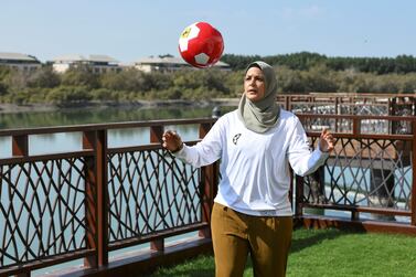 Assmaah Helal practises her football skills in Abu Dhabi on Sunday. She took up the game at five, and in recent years has promoted social change through sport. Khushnum Bhandari for The National