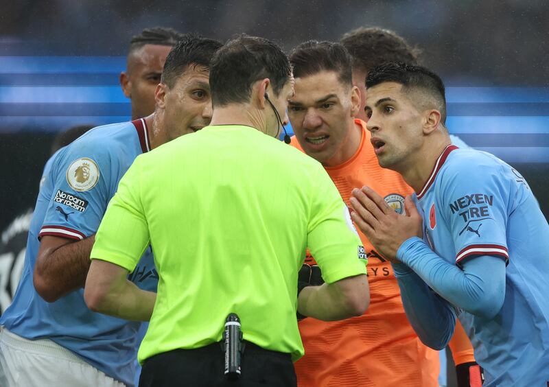 City's Joao Cancelo remonstrates with referee Darren England after a penalty is awarded and he is shown a red card. Action Images