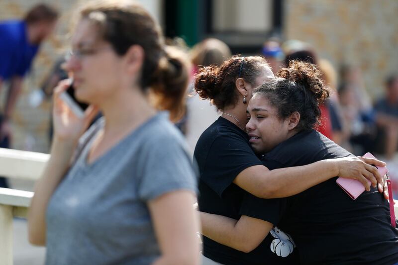 Santa Fe High School junior Guadalupe Sanchez, 16, cries in the arms of her mother, Elida Sanchez, after reuniting with her at a meeting point at a nearby Alamo Gym following a shooting at Santa Fe High School in Santa Fe, Texas. Michael Ciaglo / AP Photo