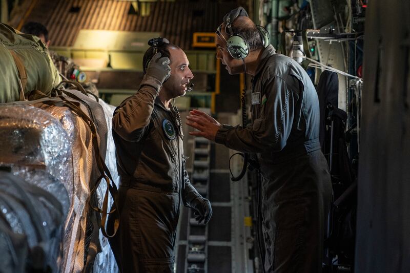 Two Jordanian Air Force loadmasters prepare an aid drop over Gaza on 20 March, 2024. 