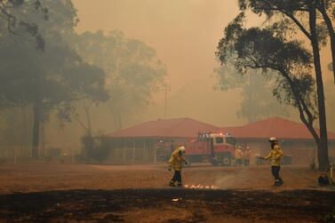 New South Wales (NSW) Rural Fire Service (RFS) officers engage in property protection of a number of homes along the Old Hume Highway near the town of Tahmoor, NSW, Australia, 19 December 2019. EPA