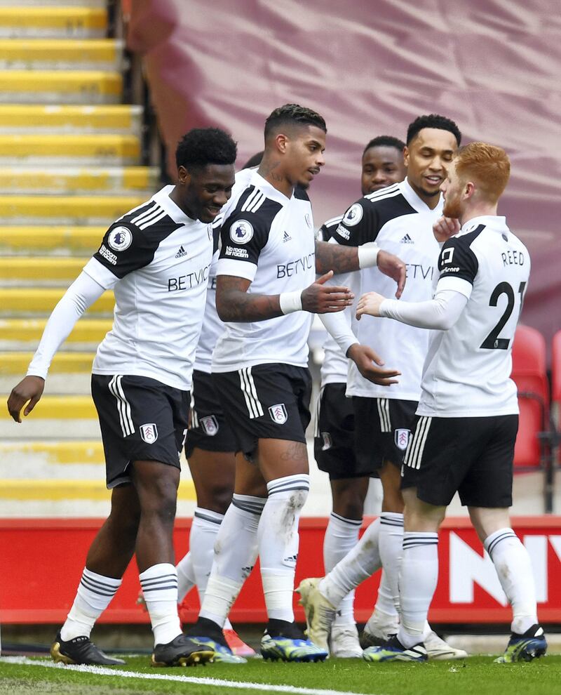 LIVERPOOL, ENGLAND - MARCH 07: Mario Lemina of Fulham celebrates with Harrison Reed and team mates after scoring their side's first goal during the Premier League match between Liverpool and Fulham at Anfield on March 07, 2021 in Liverpool, England. Sporting stadiums around the UK remain under strict restrictions due to the Coronavirus Pandemic as Government social distancing laws prohibit fans inside venues resulting in games being played behind closed doors. (Photo by Paul Ellis - Pool/Getty Images)