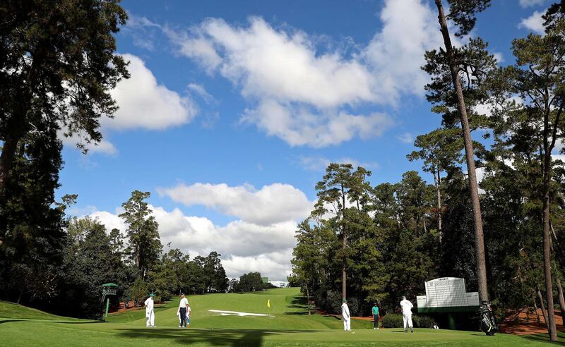 Tiger Woods, Justin Thomas, Bryson DeChambeau and Fred Couples putt on the 10th green during a practice round prior to the Masters. AFP