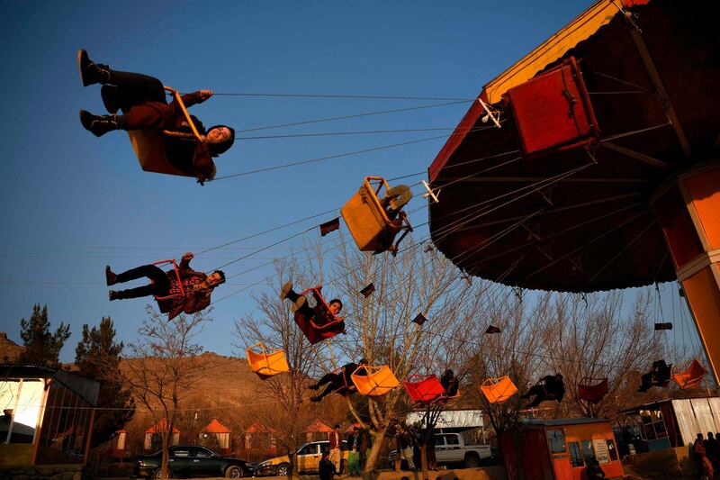 Afghans sit on a fairground ride at the Qargha lake on the outskirts of Kabul.  AFP