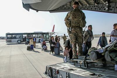British and dual citizens living in Afghanistan board a military plane at Kabul airport. Reuters