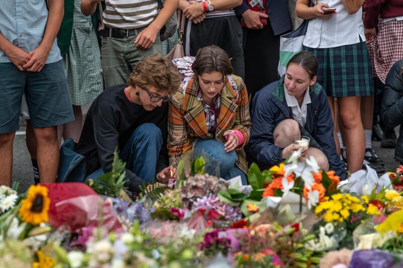 CHRISTCHURCH, NEW ZEALAND - MARCH 18: People place a candle among flowers and tributes near Al Noor mosque on March 18, 2019 in Christchurch, New Zealand. 50 people were killed, and dozens are still injured in hospital after a gunman opened fire on two Christchurch mosques on Friday, 15 March. The accused attacker, 28-year-old Australian, Brenton Tarrant, has been charged with murder and remanded in custody until April 5. The attack is the worst mass shooting in New Zealand's history. (Photo by Carl Court/Getty Images)