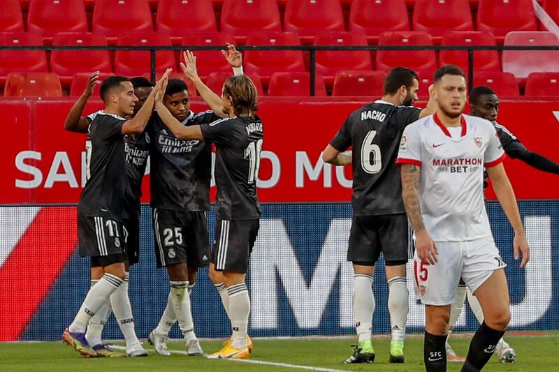 Real Madrid's players celebrate their goal against Sevilla at the Ramon Sanchez Pizjuan Stadium. AP