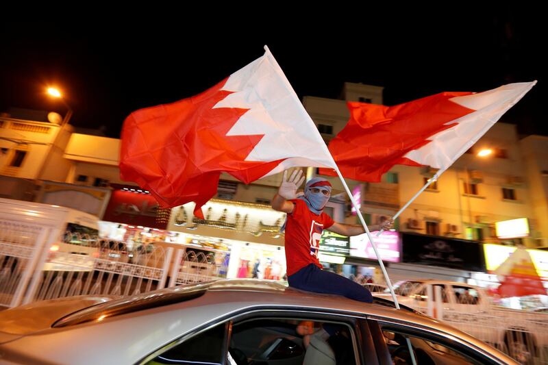 Bahrainis wave flags from moving cars after winning the Gulf Cup final against Saudi Arabia, in Riffa, south of Manama, Bahrain. Reuters