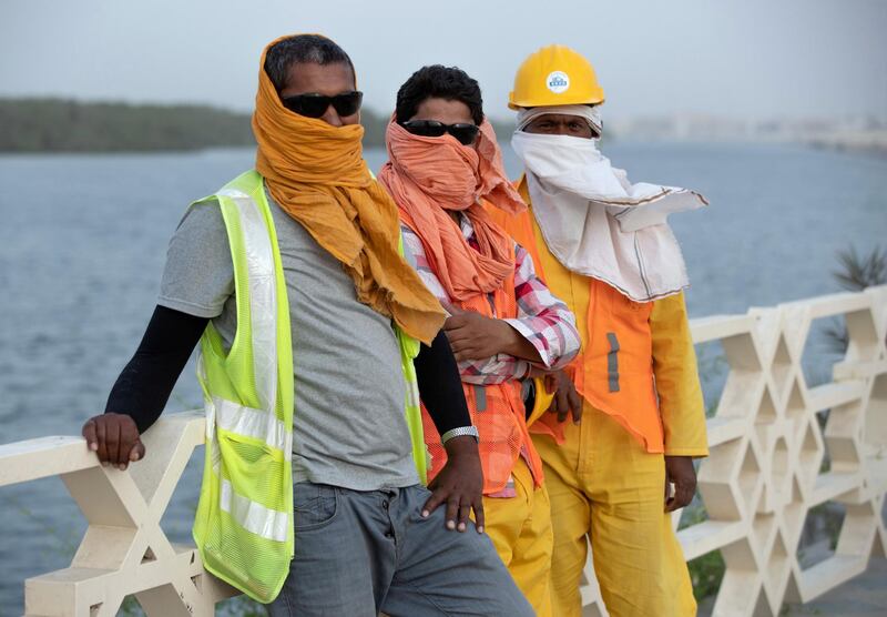 Abu Dhabi, United Arab Emirates, October 7, 2019.  
Sandy weather. --  Mangrove area roadwork workers cover themselves from the elements because of a sandstorm.
Victor Besa / The National
Section:  NA
Reporter: