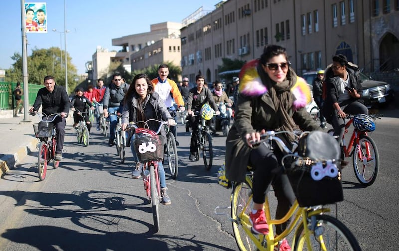 Marina Jaber, centre, known to many as 'the girl on the bike', is inspiring Iraqi women to exercise their freedoms. Ahmad Mousa / AFP