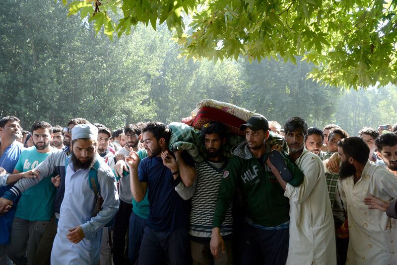 Kashmiri villagers carry the body of slain militant Ayub Lelhari during his funeral procession at Lelhar village of Pulwama district, south of Srinagar. Indian security forces killed Ayub during a brief gunfight on the evening of August 16, police said. Tauseef Mustafa / AFP.