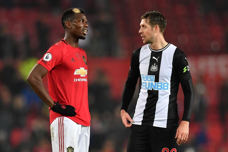 Paul Pogba talks to Newcastle United's French midfielder Florian Lejeune. AFP