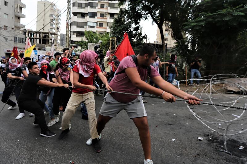 Protesters try to remove barbed wire during a demonstration by supporters of Hezbollah, Lebanese communist party, and other Lebanese national parties during a demonstration at the US embassy against US interference in Lebanon's affairs, in Awkar area north-east Beirut, Lebanon. EPA