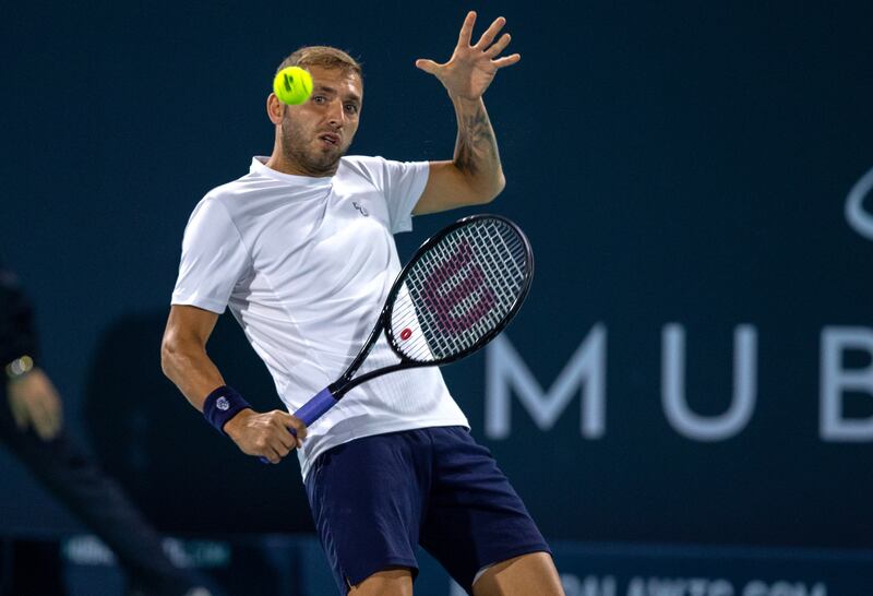 Daniel Evans returns a shot to Andy Murray during their match at the Mubadala World Tennis Championship. Victor Besa / The National